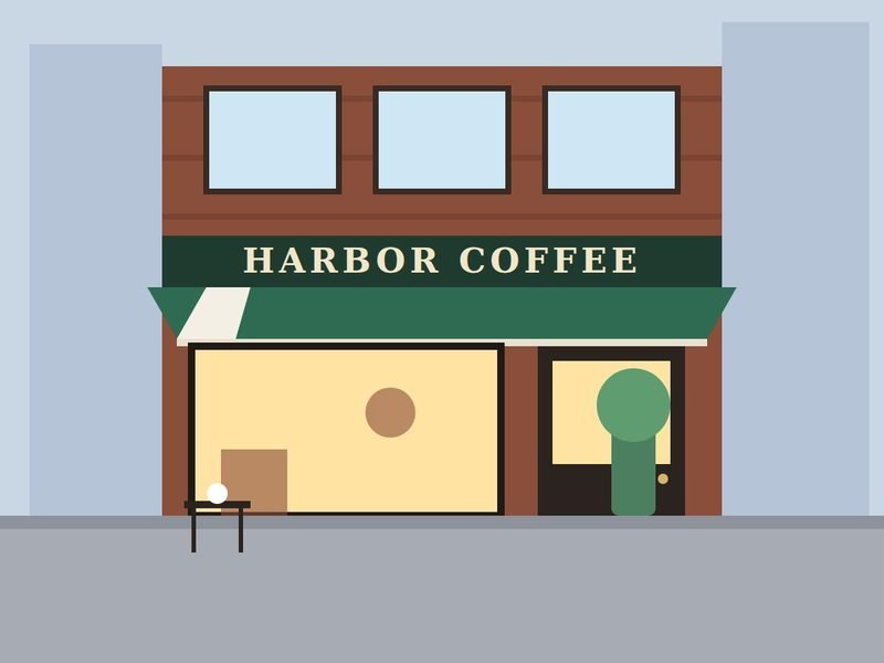 Brick café storefront with a green awning and large lit window