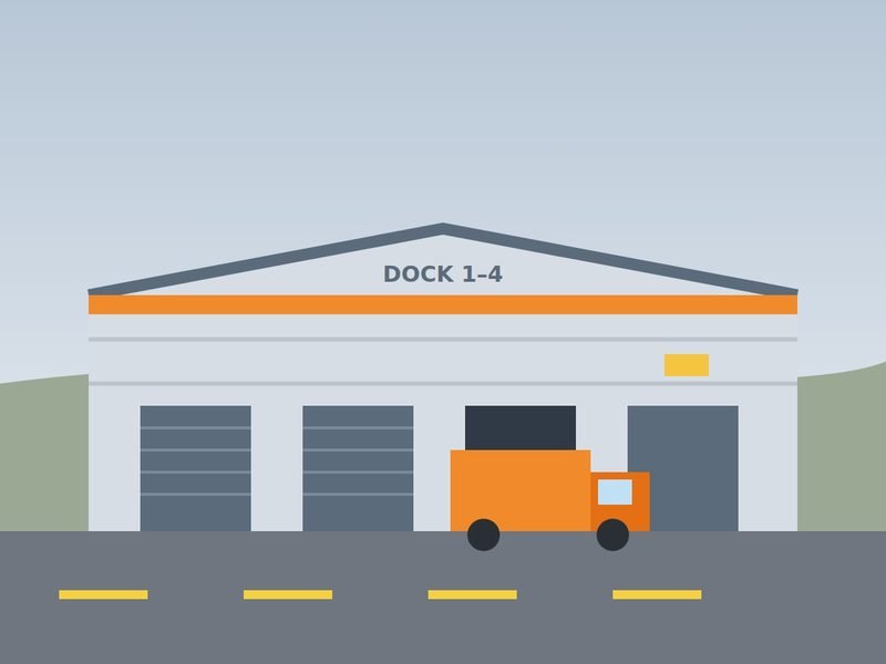 Large grey warehouse with an orange stripe, four loading docks and a delivery truck